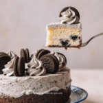 Cookies and Cream Cake Easy Recipe for Oreo Lovers 2 Close-up of a freshly made Easy Cookies and Cream Cake with Box Mix served in a rustic ceramic bowl, vibrant vegetables and sauce glistening under soft natural light, warm farmhouse kitchen tones, shallow depth of field, no steam or smoke --v 6 --style raw --ar 2:3 at the top center and website URL 'www.homecookmealsrecipes.com ' at the bottom center of the image, clean modern font, well-balanced layout,