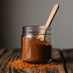close up of homemade taco seasoning in a rustic glass jar with a wooden spoon vibrant chili and cum lwfe33dorzo12m4djjxe 2