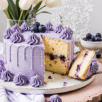 Lavender Cake: A Delicate Floral Delight 2 close up of lavender cake on a rustic wooden table delicate purple hue topped with icing drizzle a 704i1ydw7fe2ou1vjwzk 1