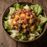 close up of taco salad in a rustic bowl vibrant colors of lettuce beef cheese and tomatoes cozy nat i7m0ufbt89vhmxyyo6sa 0