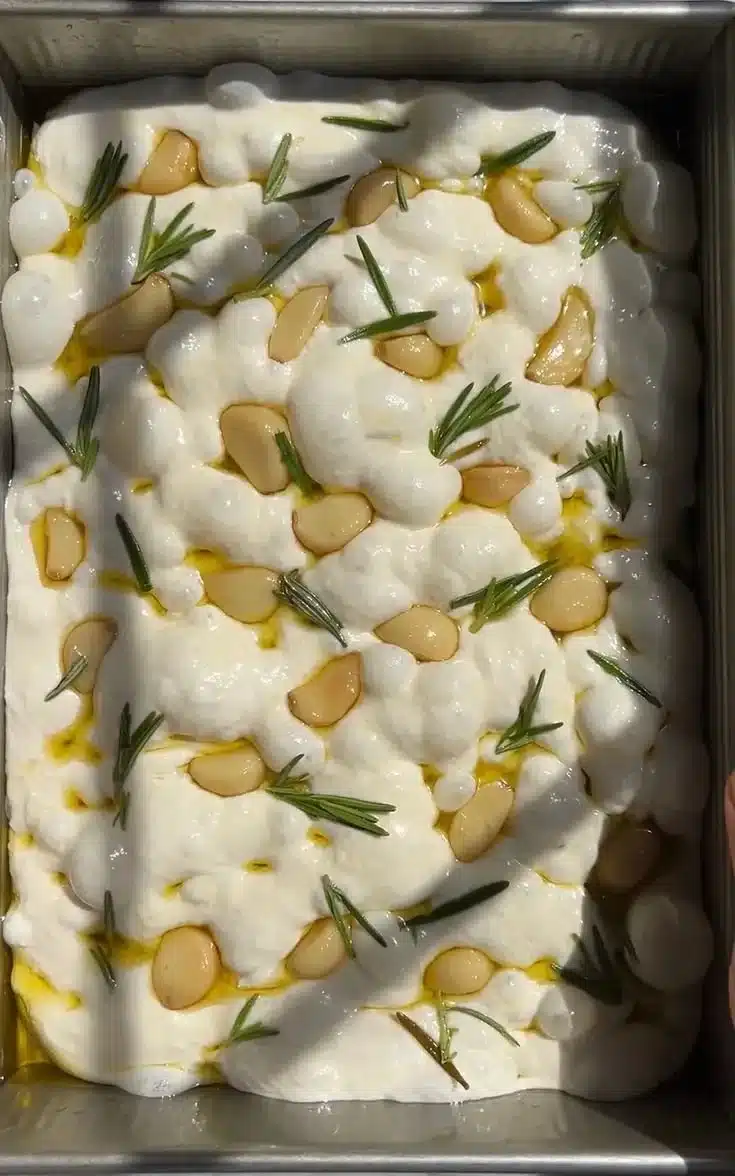 Homemade easy sourdough focaccia bread with herbs and olive oil