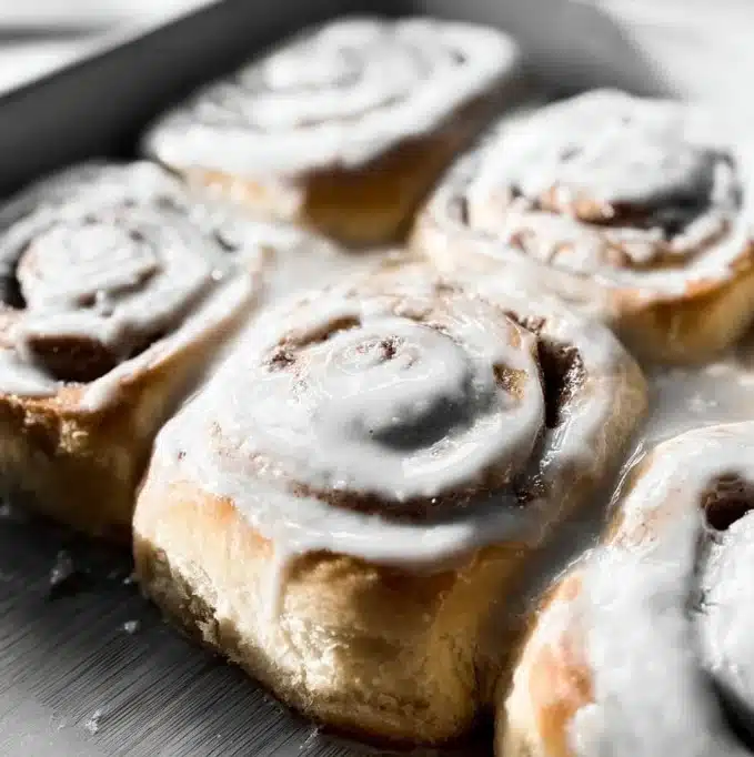 Delicious homemade cinnamon rolls with icing on a table