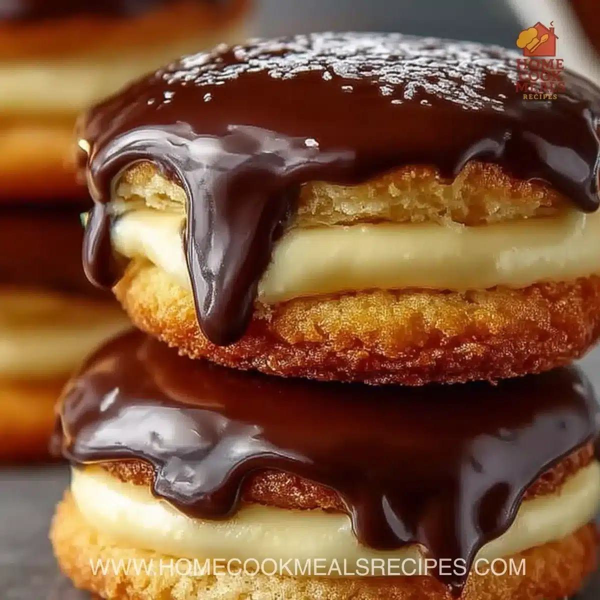 Boston Cream Pie Cookies on a plate with chocolate ganache topping
