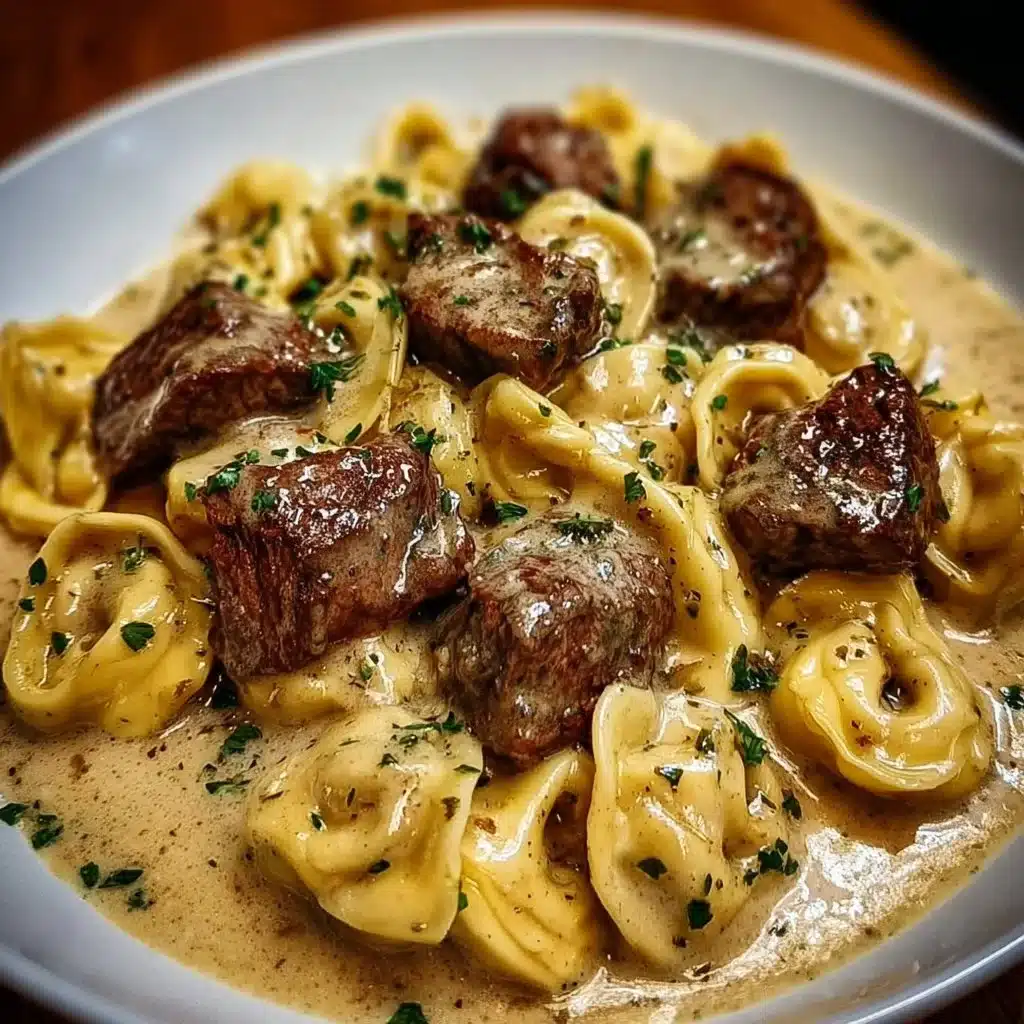 Plate of cracked garlic steak tortellini served in creamy sauce