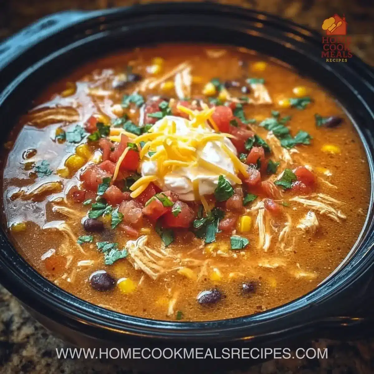 Bowl of Crockpot Chicken Tortilla Soup topped with tortilla strips and avocado.