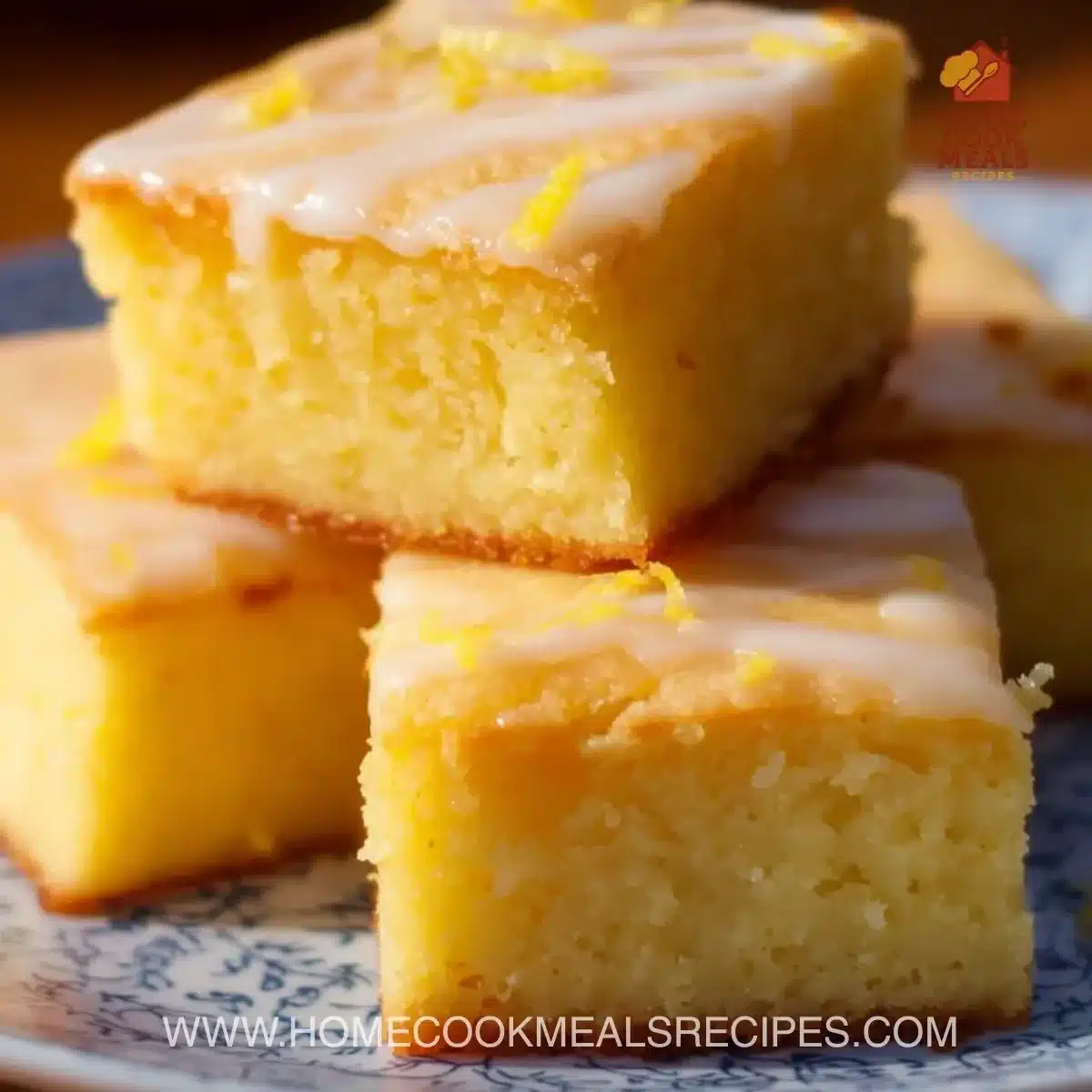 Delicious lemon brownies topped with powdered sugar on a plate