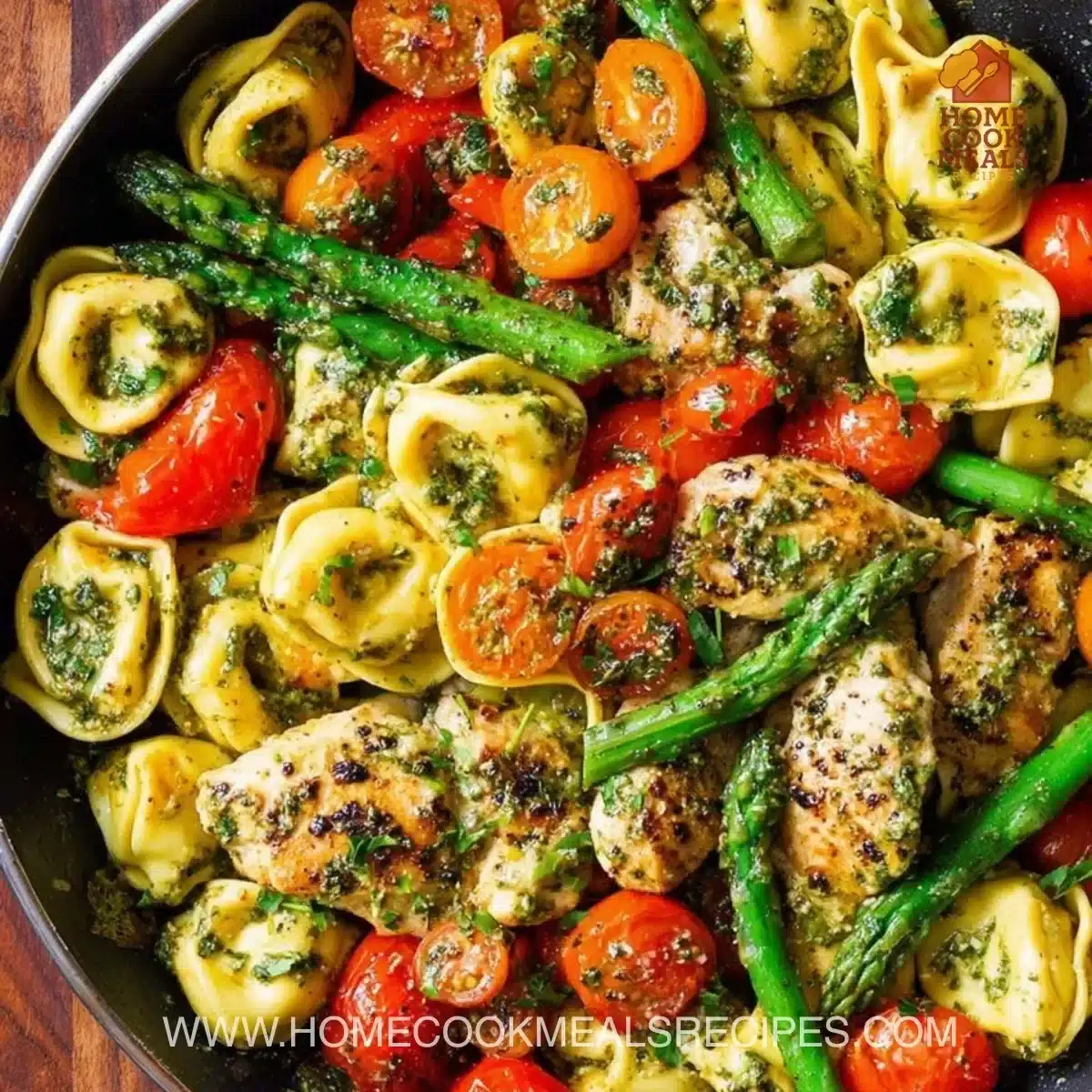 One-pan pesto chicken served with tortellini and colorful vegetables