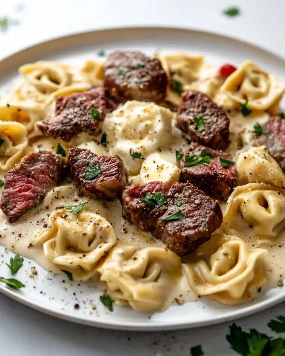 Cracked garlic steak tortellini in creamy sauce served on a plate