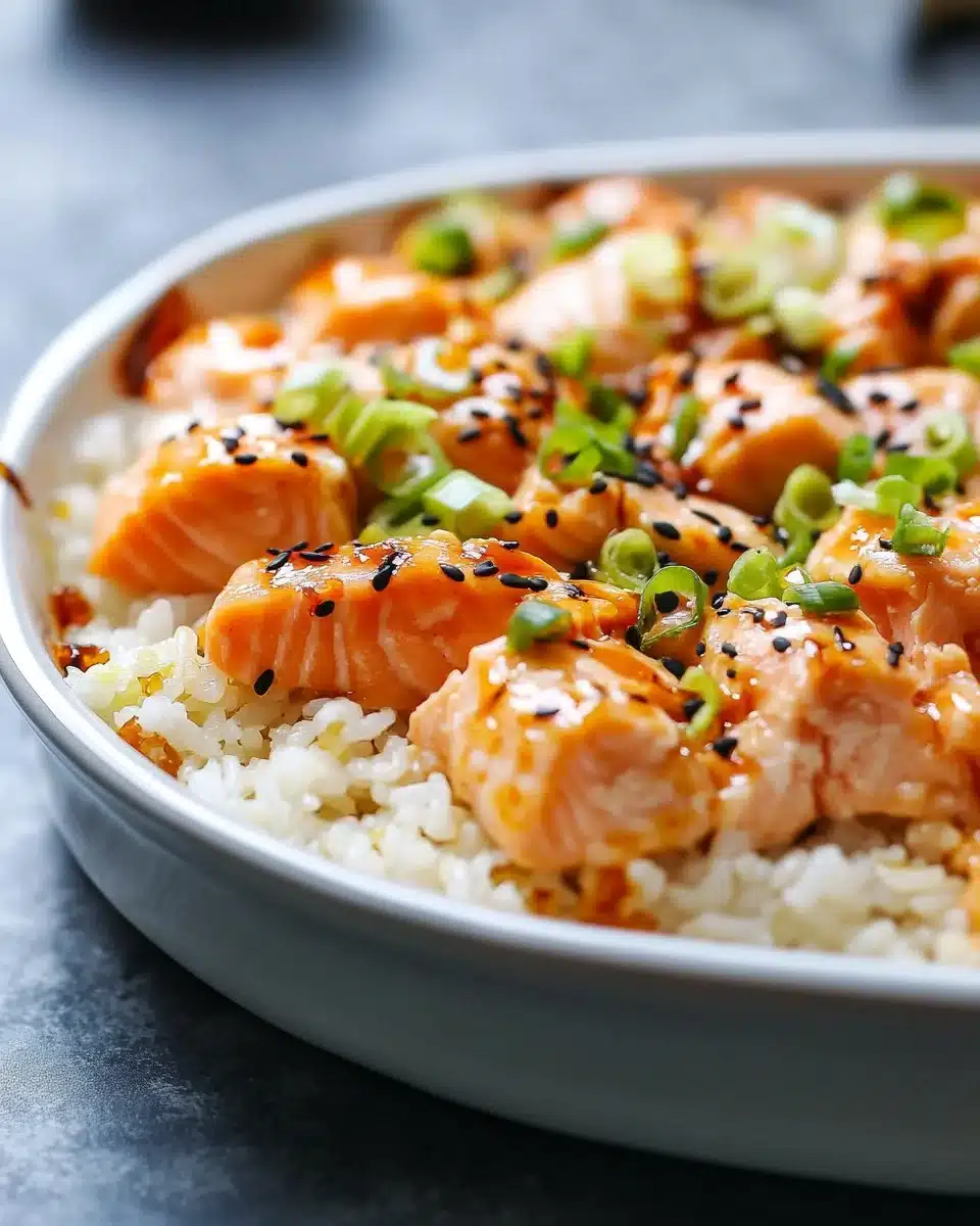 Baked spicy salmon sushi topped with scallions and served in a dish