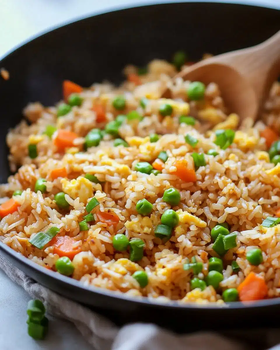 A plate of delicious Hibachi Fried Rice garnished with vegetables and shrimp.