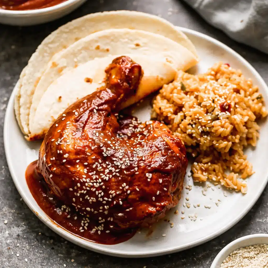 Delicious homemade mole recipe served over chicken with tortillas and rice on the side.