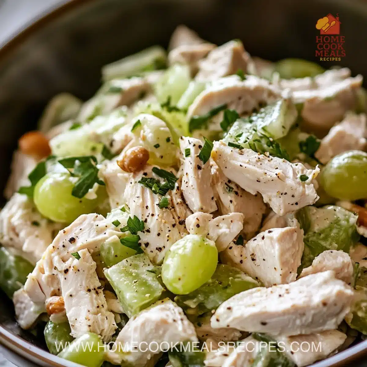 Fresh chicken salad with vegetables and dressing served in a bowl.