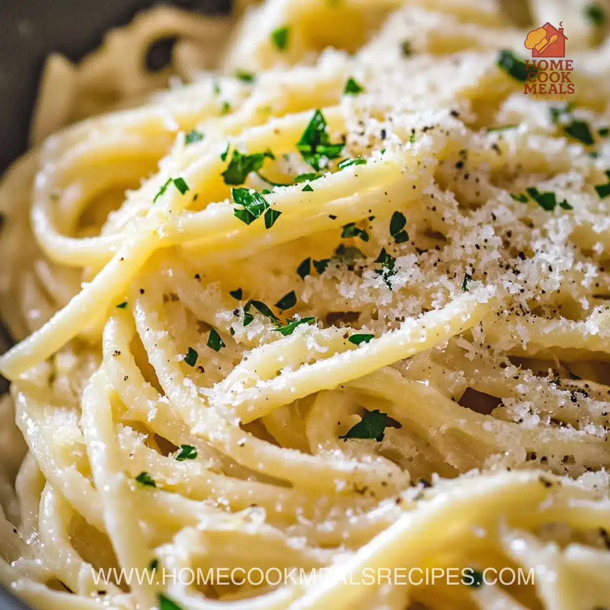 Plate of Garlic Lemon Parmesan Pasta garnished with herbs and cheese.