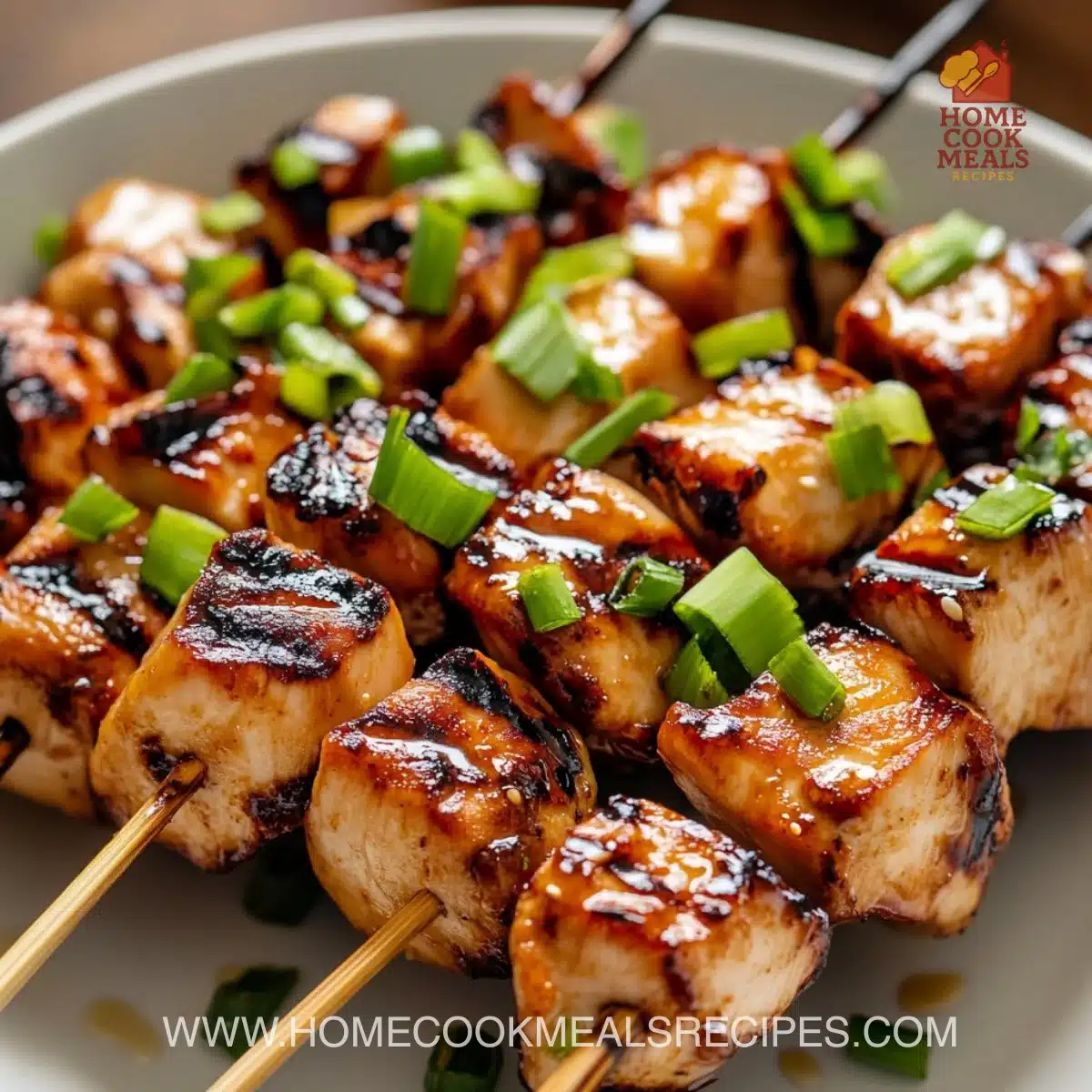 Delicious grilled chicken yakitori skewers garnished with green onions.