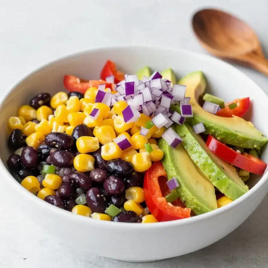 A colorful bowl of Cowboy Caviar made with black beans, corn, tomatoes, and peppers.