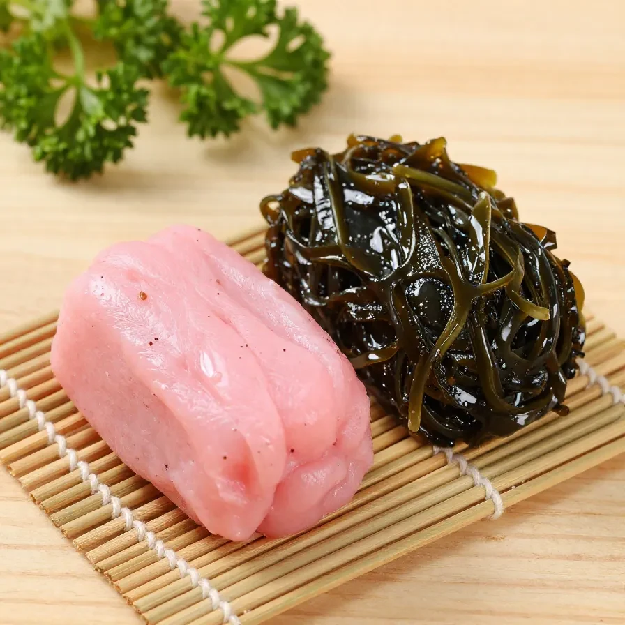 Corned beef musubi 2 A delicious corned beef musubi wrapped in seaweed with a side of pickled vegetables
